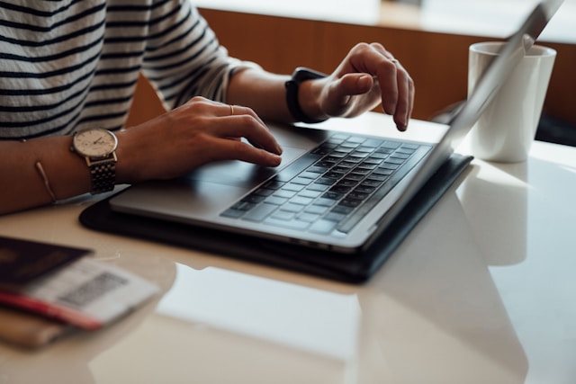 person-seated-at-the-table-using-laptop